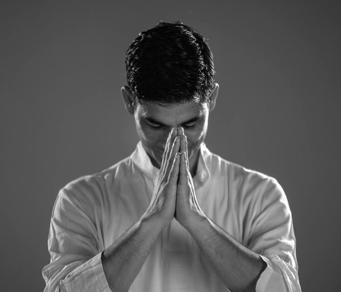 Man in a meditative pose focusing on balance and inner peace.